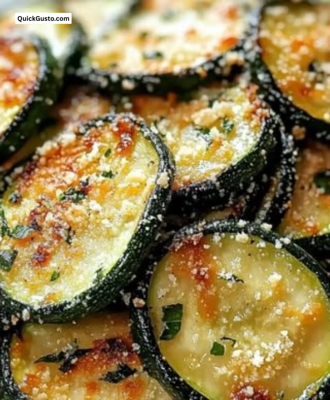Crunchy garlic parmesan roasted zucchini on a plate, garnished and ready to serve.