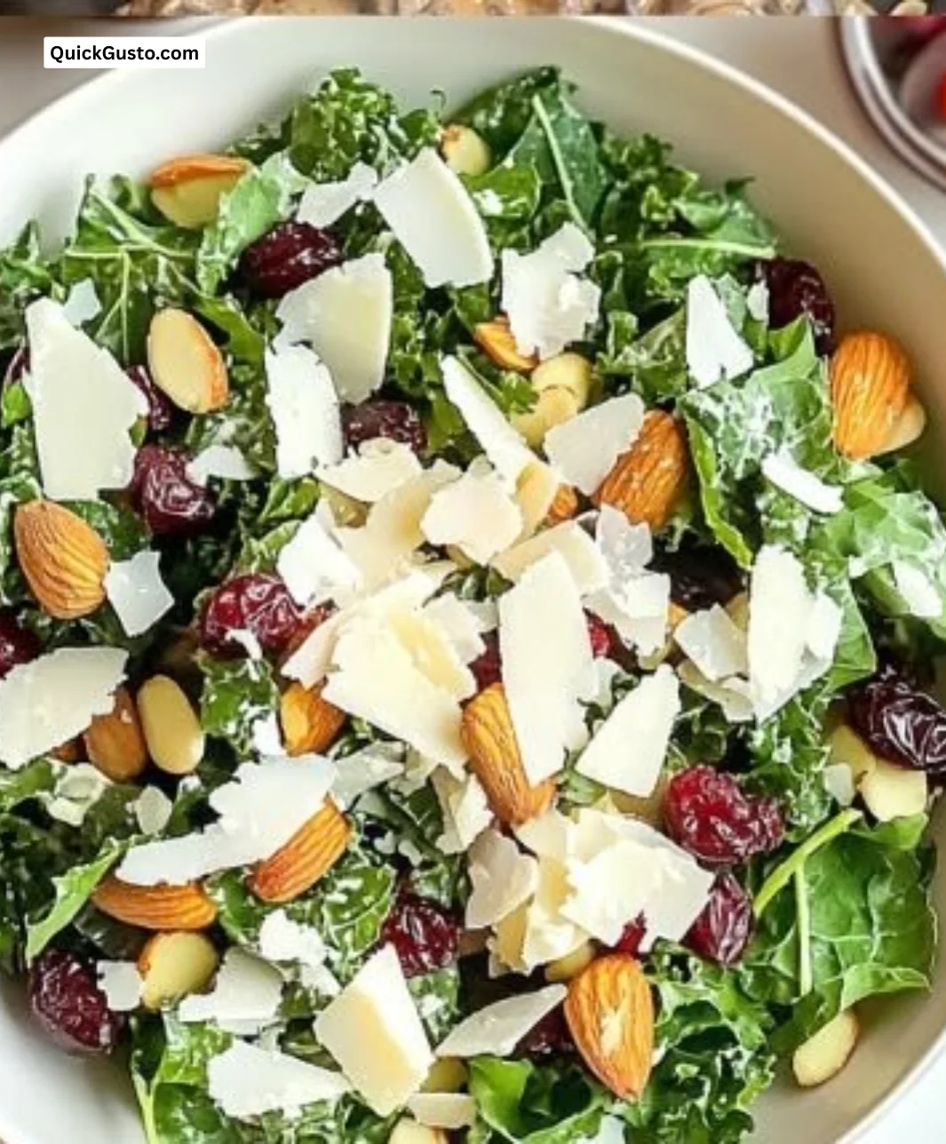 Crunchy kale salad with almonds, cranberries, and Parmesan cheese