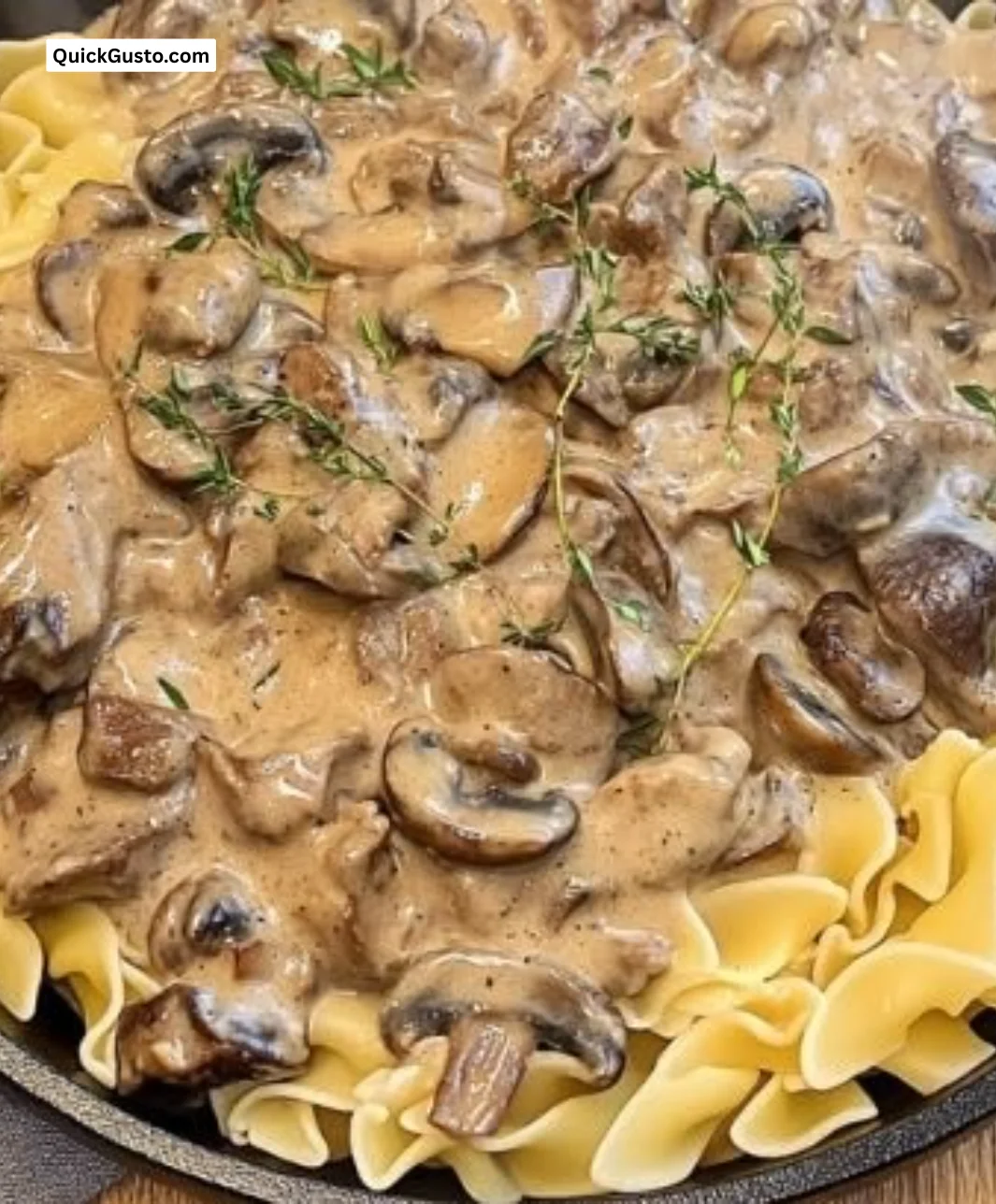 Dutch Oven Beef Stroganoff ready to serve in a pot with creamy sauce and beef.