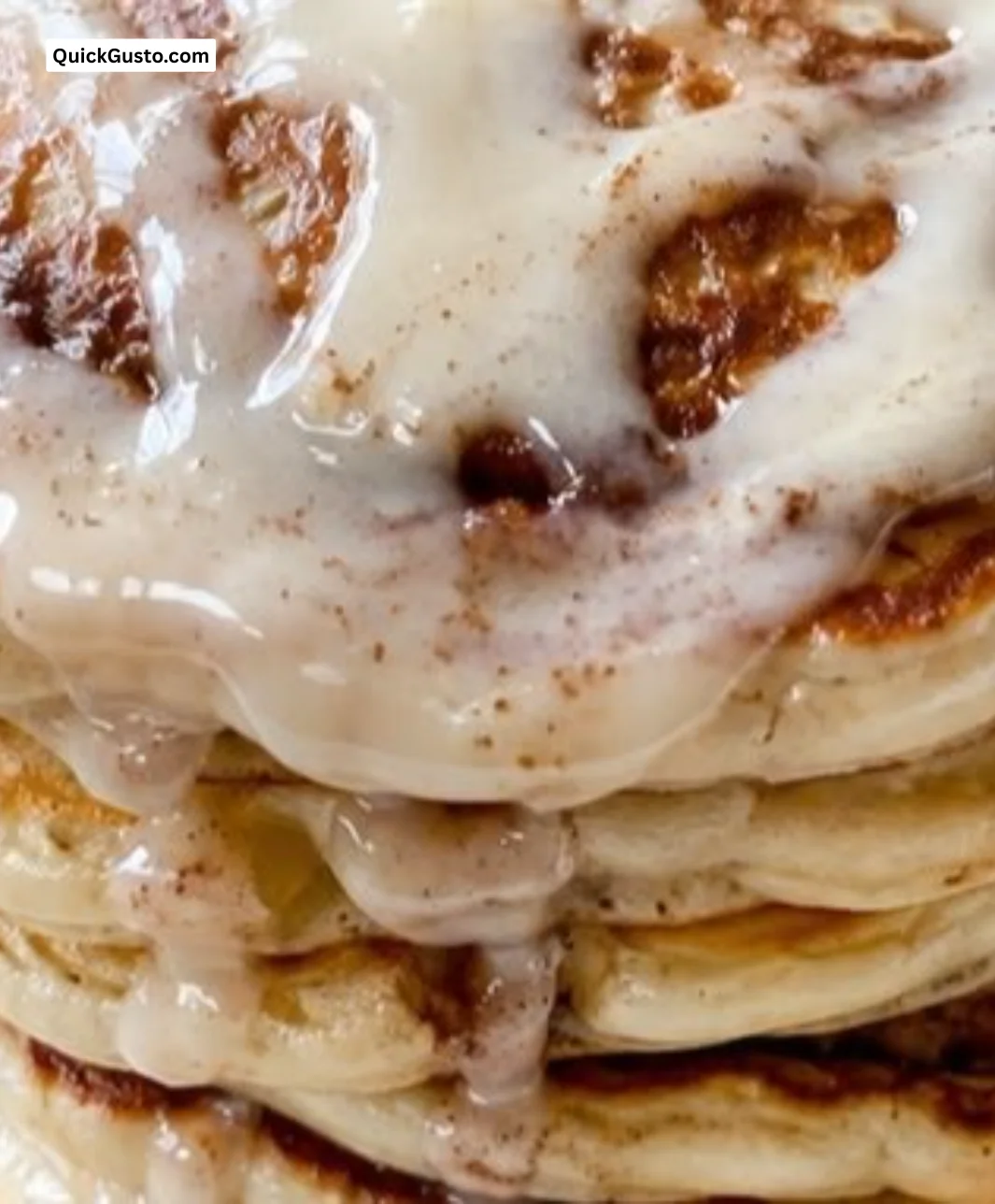 Delicious cinnamon roll pancakes topped with icing and cinnamon