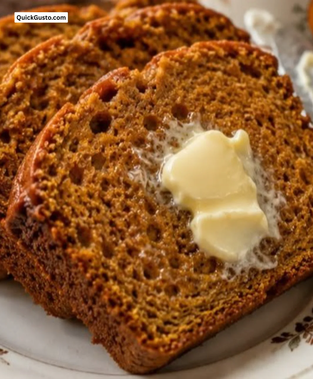 Freshly baked easy pumpkin bread with fall spices on a wooden table