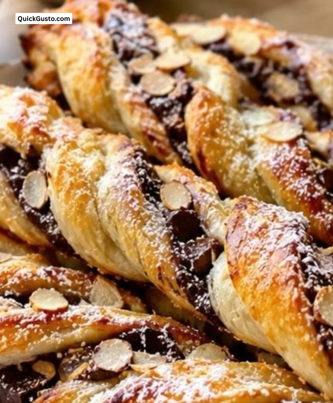 Assorted French breakfast pastries including croissants and tarts on a table.