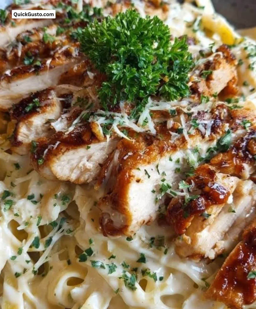 Honey BBQ Chicken Alfredo pasta dish topped with grilled chicken and BBQ sauce