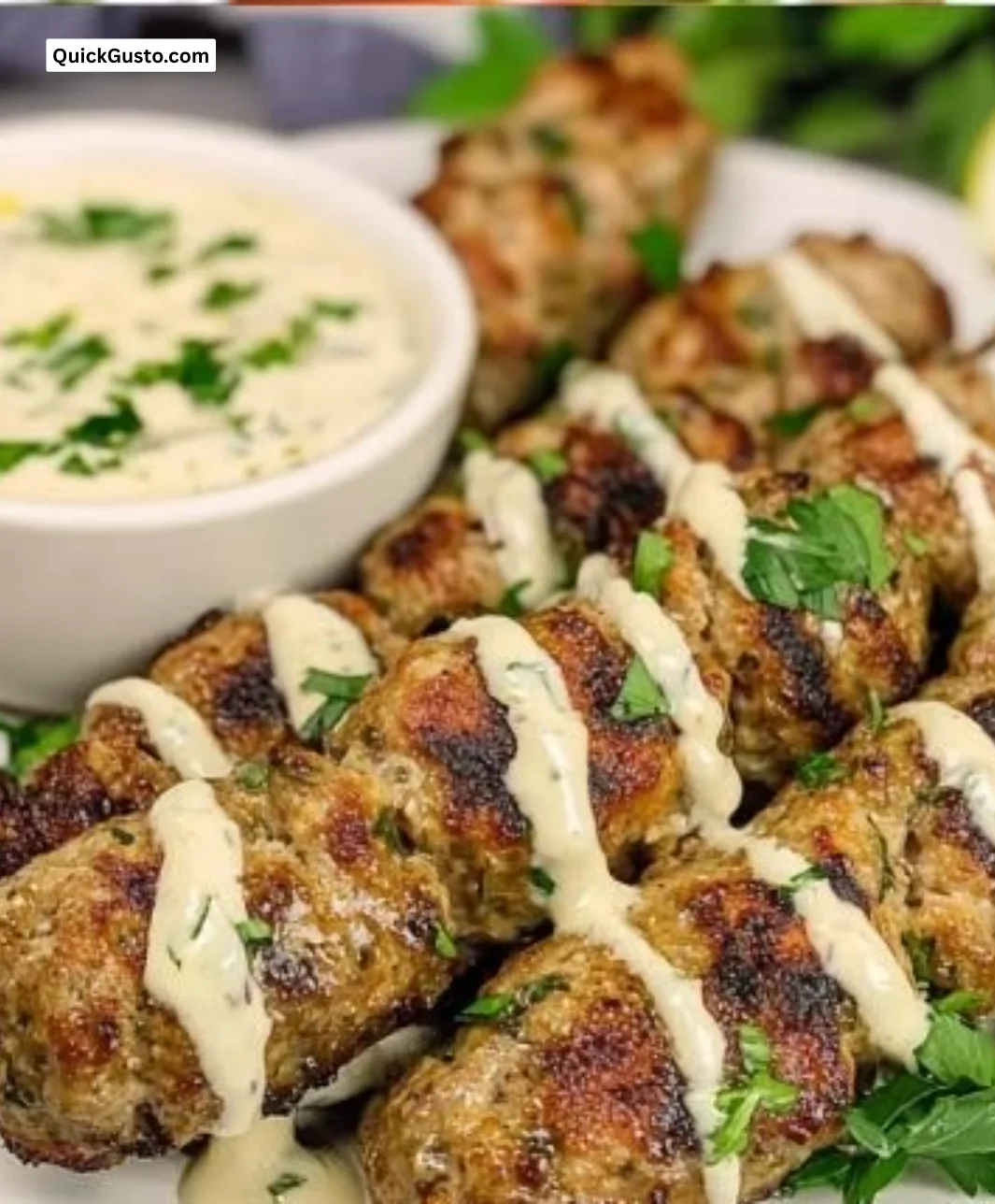 Delicious Pork Kofta Kebabs served with tahini sauce on a platter