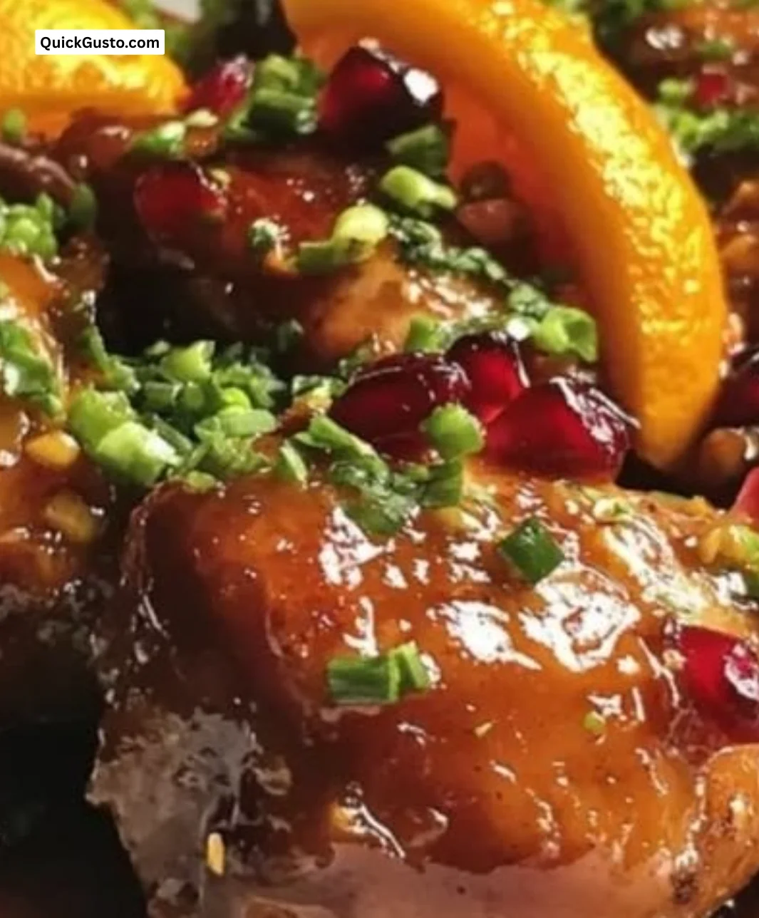 Succulent glazed duck legs with pomegranate and orange sauce on a plate.