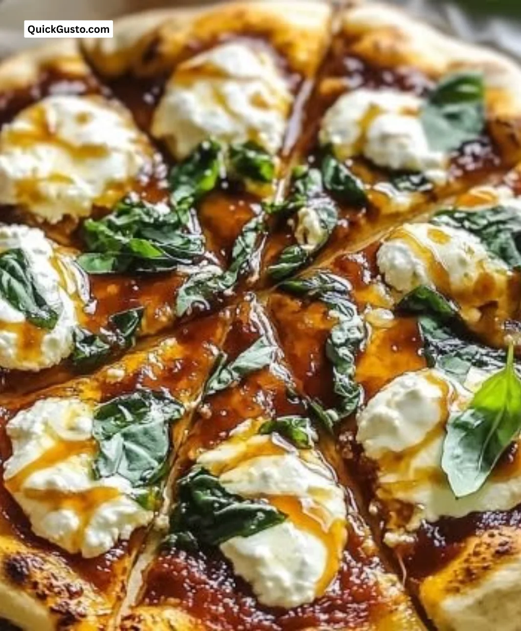 Savory hot honey ricotta pizza topped with drizzles of hot honey and fresh herbs.