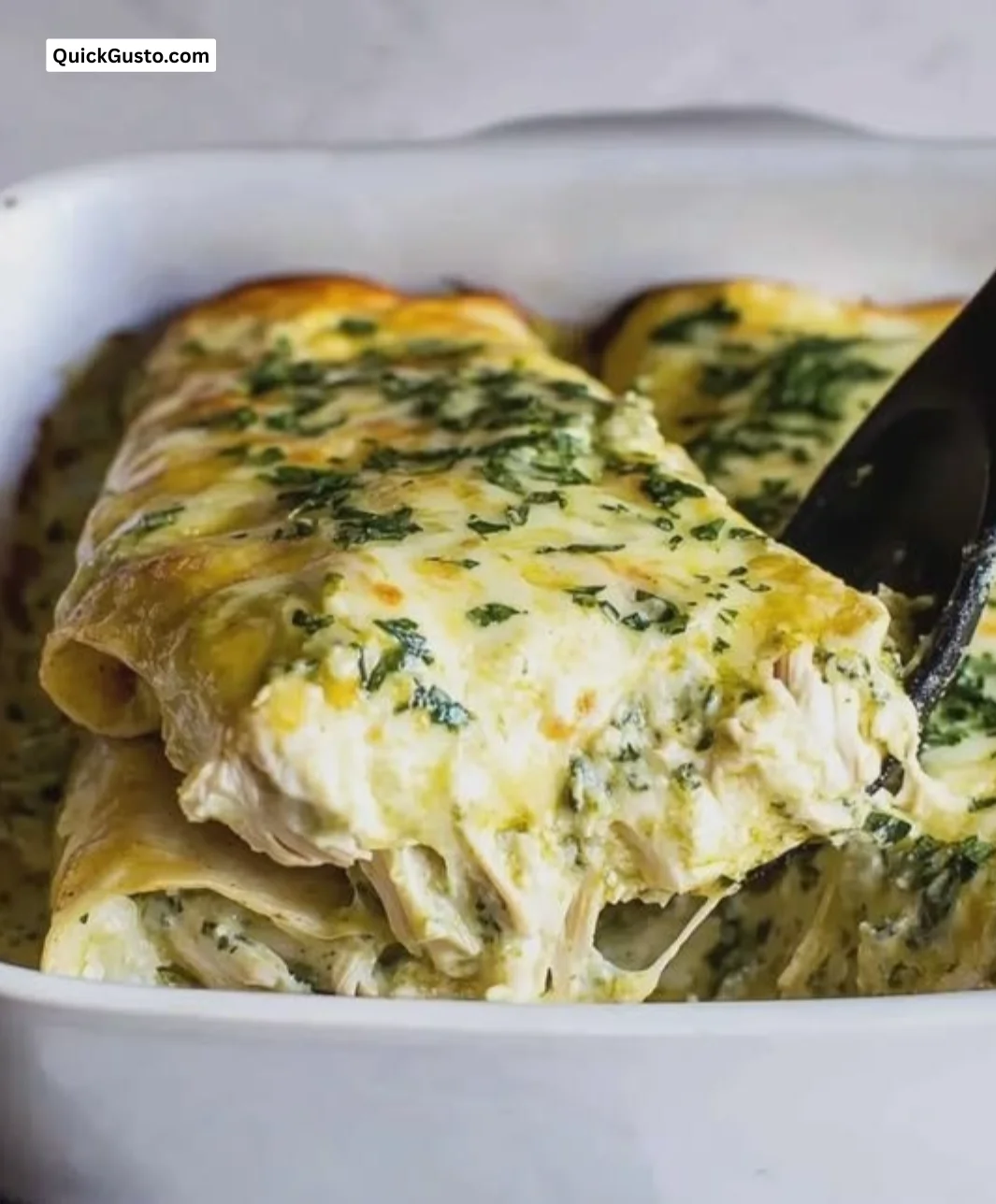 Smoky poblano chicken enchiladas topped with cheese and fresh herbs.
