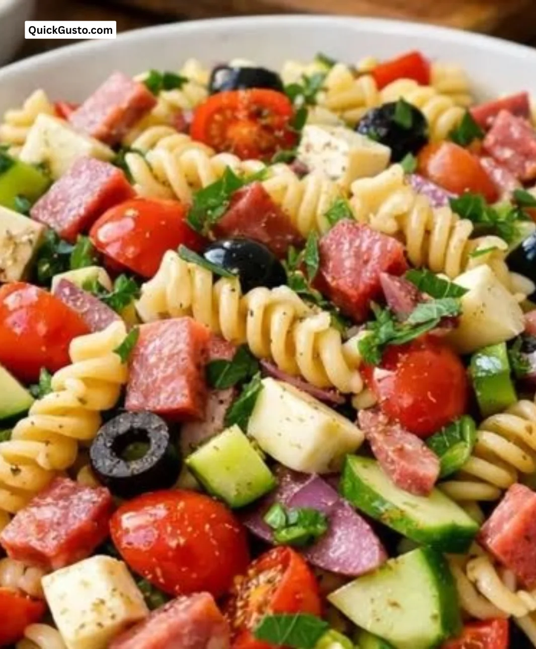 Colorful sun-kissed Italian pasta salad with fresh vegetables and dressing