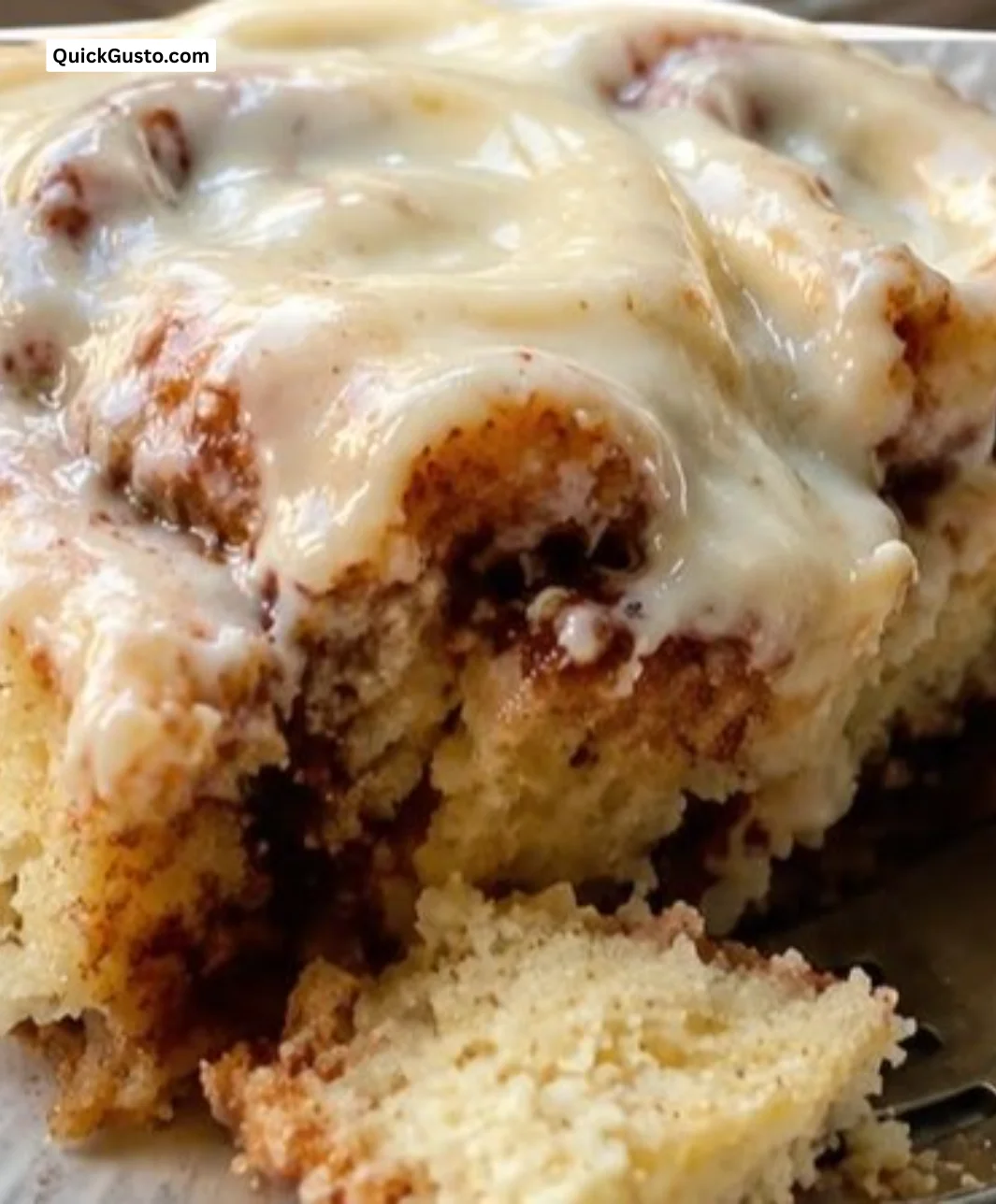 Delicious cinnamon roll cake with cream cheese glaze and swirls of cinnamon.