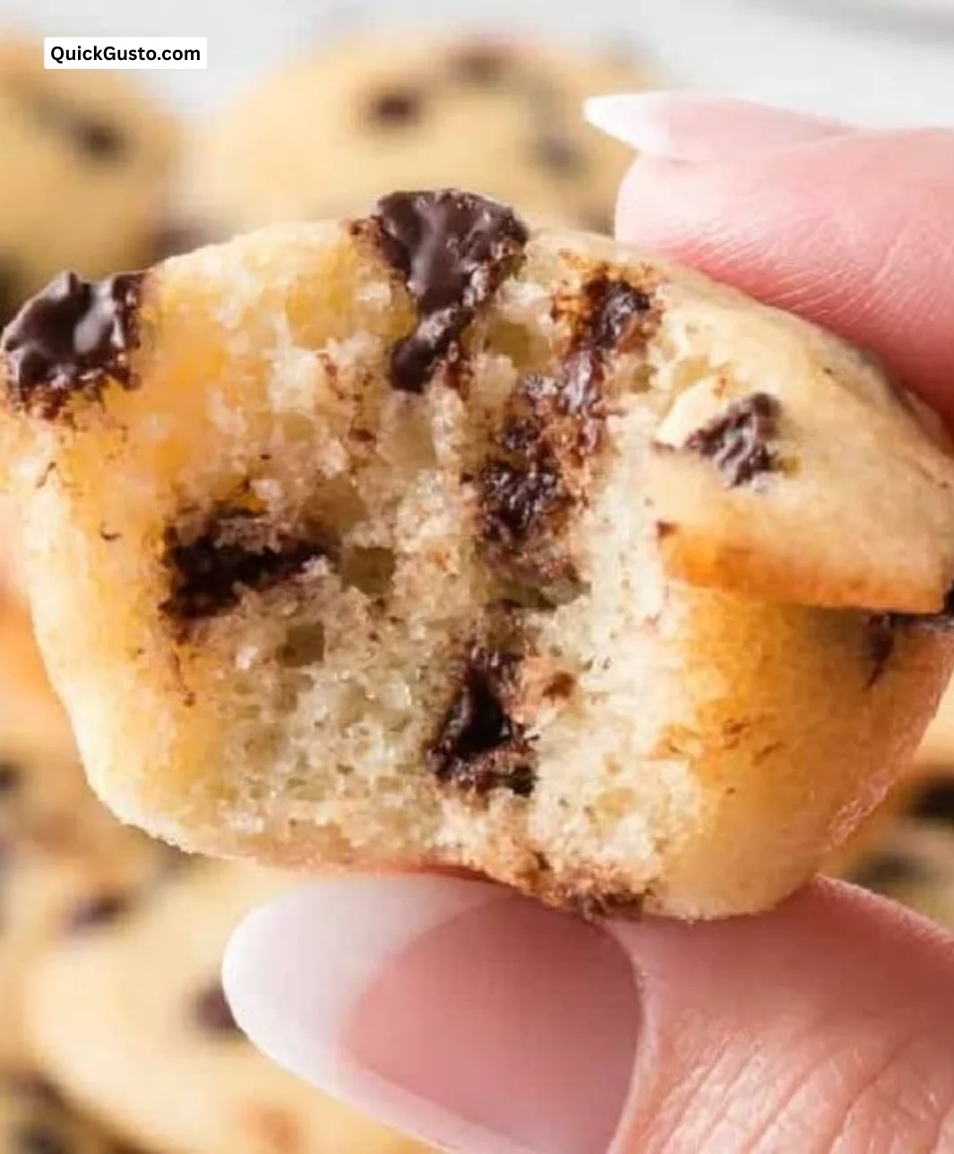 Freshly baked tiny chocolate chip muffins on a cozy kitchen table