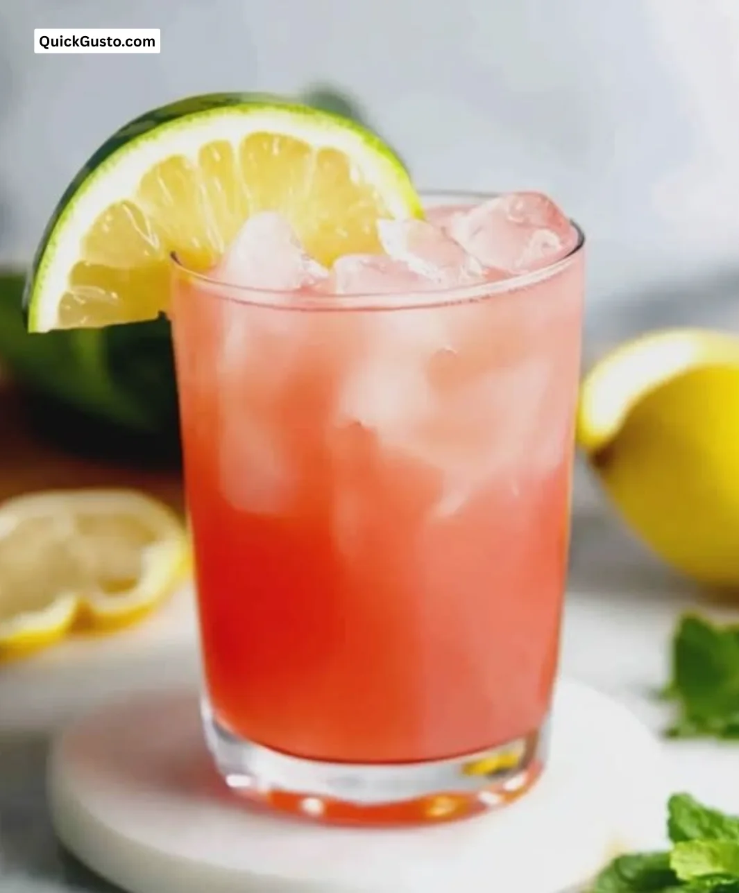 Refreshing watermelon lemonade served in a glass with ice and lemon slices